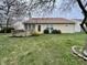 A spacious backyard featuring a wooden deck, lush green grass, and tidy landscaping at 6083 White Birch Dr, Fishers, IN 46038