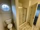 The bathroom offers a clean, bright space with a tiled shower and convenient commode area at 6083 White Birch Dr, Fishers, IN 46038