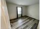 Bedroom with vinyl flooring, a window with curtains, and bright natural light at 6083 White Birch Dr, Fishers, IN 46038