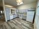 Well-lit kitchen featuring modern appliances, ample cabinet space, and stylish vinyl floors at 6083 White Birch Dr, Fishers, IN 46038