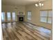 Bright and airy living room with a fireplace, vinyl flooring, and French doors to the patio at 6083 White Birch Dr, Fishers, IN 46038