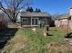 The backyard of the home features a grassy area, a burn barrel, and a partial fence at 635 Laclede St, Indianapolis, IN 46241