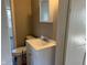 Bathroom with a white vanity, mirror, and toilet, showcasing compact design at 635 Laclede St, Indianapolis, IN 46241