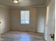 Bedroom with light wood floors, a window with blinds, and neutral walls at 635 Laclede St, Indianapolis, IN 46241