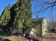 Charming home exterior with mature trees and a partially fenced yard at 635 Laclede St, Indianapolis, IN 46241