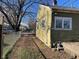 Side yard view of a home featuring a chain-link fence and partial driveway at 635 Laclede St, Indianapolis, IN 46241