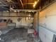 An unfinished garage space with exposed wood beams and a dirt floor offers potential for customization at 635 Laclede St, Indianapolis, IN 46241