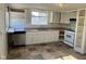 A kitchen features neutral cabinetry and a double basin sink with natural light from the window at 635 Laclede St, Indianapolis, IN 46241