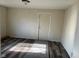 View of a vacant living room with wood-look flooring and a gray rug at 635 Laclede St, Indianapolis, IN 46241