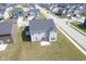Aerial view of a home's backyard with a small patio and swing, surrounded by a peaceful neighborhood at 7140 Leatherwood Dr, Indianapolis, IN 46259