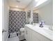 Modern bathroom featuring double sinks, stylish patterned shower curtain, and ample counter space at 7140 Leatherwood Dr, Indianapolis, IN 46259