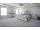 Spacious bedroom with carpet, a ceiling fan, a bed, vanity and windows at 7140 Leatherwood Dr, Indianapolis, IN 46259
