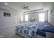Spacious bedroom with carpet, a ceiling fan, a bed, vanity and windows at 7140 Leatherwood Dr, Indianapolis, IN 46259