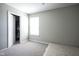 Bedroom with carpet, closet with hanging clothes, a window and a mattress on the floor at 7140 Leatherwood Dr, Indianapolis, IN 46259
