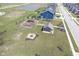 Aerial view of a neighborhood park with playground, picnic shelter, and fire pit, plus a small lake at 7140 Leatherwood Dr, Indianapolis, IN 46259