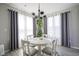 Bright and inviting dining area with modern chandelier and natural light at 7140 Leatherwood Dr, Indianapolis, IN 46259