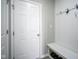 Clean entryway with a white door, a built-in bench, and coat hooks, offering a welcoming entrance at 7140 Leatherwood Dr, Indianapolis, IN 46259