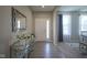 Elegant foyer featuring stylish console table with mirror and views to the living area at 7140 Leatherwood Dr, Indianapolis, IN 46259