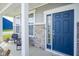 View of the front door, stone facade, and porch with two chairs at 7140 Leatherwood Dr, Indianapolis, IN 46259