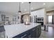 Spacious kitchen island with quartz countertops and seating is open to the living room at 7140 Leatherwood Dr, Indianapolis, IN 46259