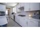 Modern kitchen features white cabinets, stainless steel appliances, and ample counter space at 7140 Leatherwood Dr, Indianapolis, IN 46259