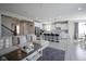 Open-concept living area showcasing a comfortable sectional sofa and bright, airy kitchen at 7140 Leatherwood Dr, Indianapolis, IN 46259