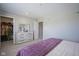 Neutral main bedroom with light dresser, plush purple blanket and a walk-in closet for ample storage at 7140 Leatherwood Dr, Indianapolis, IN 46259