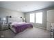 Bright main bedroom with a wooden headboard bed, two side tables and a large window offering natural light at 7140 Leatherwood Dr, Indianapolis, IN 46259
