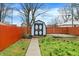 Backyard featuring a storage shed with a decorative door, fenced perimeter, and ample green space at 725 N Sheffield Ave, Indianapolis, IN 46222