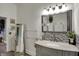 Elegant bathroom with a marble countertop vanity, decorative mirror, and sleek fixtures at 725 N Sheffield Ave, Indianapolis, IN 46222