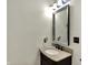 Modern bathroom featuring a dark vanity with a granite countertop and minimalist decor at 725 N Sheffield Ave, Indianapolis, IN 46222