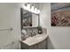 Chic bathroom featuring a vanity with marble countertop, decorative mirror, and tiled backsplash at 725 N Sheffield Ave, Indianapolis, IN 46222