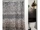 Cozy bathroom featuring a patterned shower curtain and a dark cabinet above the toilet at 725 N Sheffield Ave, Indianapolis, IN 46222