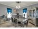Modern dining room featuring gray walls, stylish silver furniture, and elegant decor and contemporary lighting at 725 N Sheffield Ave, Indianapolis, IN 46222