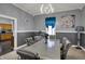 Modern dining room with gray walls, stylish silver furniture, with kitchen view and modern light fixtures at 725 N Sheffield Ave, Indianapolis, IN 46222