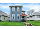 Charming two-story home featuring blue siding and a welcoming front porch on a well-maintained lawn at 725 N Sheffield Ave, Indianapolis, IN 46222