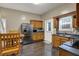Charming kitchen featuring stainless steel appliances, wood cabinets, and dark hardwood floors at 725 N Sheffield Ave, Indianapolis, IN 46222