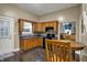 Cozy kitchen with warm wooden cabinets, mosaic backsplash, and modern appliances plus dining area at 725 N Sheffield Ave, Indianapolis, IN 46222