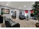Inviting living room with gray walls, plush carpeting, and comfortable black leather reclining sofas at 725 N Sheffield Ave, Indianapolis, IN 46222