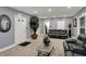 Spacious living room featuring modern gray walls, plush carpeting, and comfortable leather furniture at 725 N Sheffield Ave, Indianapolis, IN 46222