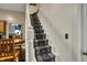 Elegant staircase with patterned carpet and white banisters, leading to the upper floor at 725 N Sheffield Ave, Indianapolis, IN 46222