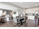 Open-concept dining area flows seamlessly to living room, with modern table and stylish decor at 7423 Standish Ln, Avon, IN 46123