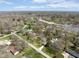 A wide angle aerial shot of a home in a suburban neighborhood with a pool at 7575 Holliday W Dr, Indianapolis, IN 46260