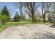Concrete patio with lawn area bordered by green trees at 7575 Holliday W Dr, Indianapolis, IN 46260
