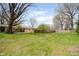 Large backyard with grass and wooden fence around property at 7575 Holliday W Dr, Indianapolis, IN 46260