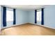 Bedroom with hardwood floors, two large windows, and light blue walls at 7575 Holliday W Dr, Indianapolis, IN 46260