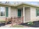 Close-up view of the front door, stone facade, green shutters, and a small ramp at 7575 Holliday W Dr, Indianapolis, IN 46260