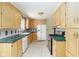 Cozy kitchen with light wood cabinets, green countertops, and stainless steel appliances at 7575 Holliday W Dr, Indianapolis, IN 46260
