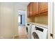 Laundry room featuring a washer and dryer, as well as cabinet storage space at 7575 Holliday W Dr, Indianapolis, IN 46260