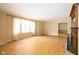 Bright living room with hardwood floors, a fireplace, and large windows bringing in natural light at 7575 Holliday W Dr, Indianapolis, IN 46260